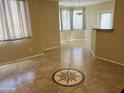 Bright living room featuring tile floors and large windows with decorative star in the center at 1941 S Pierpont Dr # 1014, Mesa, AZ 85206