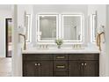 Elegant bathroom features double sinks, illuminated mirrors, and a modern design at 19550 N Grayhawk Dr # 1144, Scottsdale, AZ 85255