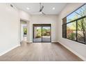 Bright living room with large window and sliding glass door, offering beautiful outdoor views at 19550 N Grayhawk Dr # 1144, Scottsdale, AZ 85255