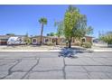 Inviting single-story home with desert landscaping and trees at 2041 E Des Moines St, Mesa, AZ 85213
