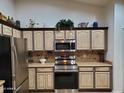 Well-equipped kitchen with stainless steel appliances, including a range and microwave, complemented by custom cabinets at 2101 S Meridian Rd # 437, Apache Junction, AZ 85120