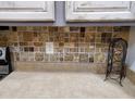 Close-up of kitchen countertop with tiled backsplash and neutral-toned surface, showcasing clean lines and functionality at 2101 S Meridian Rd # 437, Apache Junction, AZ 85120