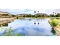 Scenic lake view reflecting the sky, trees, and mountains in the distance at 21609 N 61St Ave, Glendale, AZ 85308