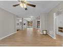 Spacious open-concept living room with hardwood floors and a view of the dining area and backyard at 2215 W Highland Ave, Phoenix, AZ 85015