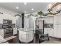 Bright kitchen featuring white cabinets, stainless steel appliances and a center island with granite countertop at 2330 E Stephens Pl, Chandler, AZ 85225