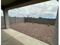 View of the private backyard featuring fresh gravel and a block wall for privacy and easy maintenance at 25183 N 183Rd Dr, Wittmann, AZ 85361