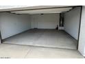 Spacious two car garage interior with a water heater and door to the interior of the house at 25183 N 183Rd Dr, Wittmann, AZ 85361