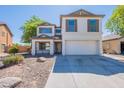 Charming two-story home with a well-manicured front yard and inviting curb appeal, painted in an attractive neutral color at 2847 S 161St Dr, Goodyear, AZ 85338