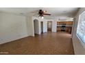Open floor plan featuring tile floors, ceiling fan, and neutral paint at 2847 S 161St Dr, Goodyear, AZ 85338