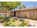 A well-maintained single-story home with a covered carport, and a mature shade tree at 31 W Loma Vista Dr # 102, Tempe, AZ 85282