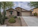 Inviting single-story home featuring a stone facade, low maintenance desert landscaping, and a spacious two-car garage at 3721 W Aracely Dr, New River, AZ 85087