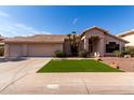 Single-story home showcasing desert landscaping, manicured lawn, and a spacious three-car garage at 3740 W Kent Dr, Chandler, AZ 85226