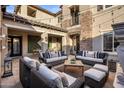 Stylish outdoor patio with comfortable wicker furniture and elegant stone accents at 3741 E Ember Glow Way, Phoenix, AZ 85050