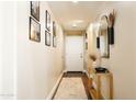 Inviting entryway with decorative mirror, console table, and a light-colored rug with framed art adding appeal at 3756 E Alamo St, San Tan Valley, AZ 85140