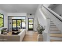Bright and airy living room with modern staircase, large windows, and stylish decor at 4120 N 44Th Pl, Phoenix, AZ 85018