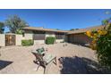 Cozy backyard patio featuring outdoor seating, desert landscaping, and decorative accents at 4126 E Windrose Dr, Phoenix, AZ 85032