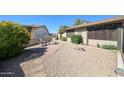 Cozy backyard patio featuring outdoor seating, desert landscaping, and decorative accents at 4126 E Windrose Dr, Phoenix, AZ 85032