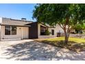 Inviting single-story home with solar panels, a well-manicured lawn, and a welcoming front entrance at 4147 W Reade Ave, Phoenix, AZ 85019