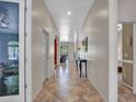 Inviting hallway featuring tile flooring, neutral paint, and decorative mirror, creating a warm and welcoming entrance at 43510 N 44Th Ave, New River, AZ 85087