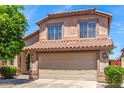 Exterior elevation featuring a two-story home with a tile roof and an attached two-car garage at 4426 E Coyote Wash Dr, Cave Creek, AZ 85331