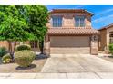 Exterior elevation featuring a two-story home with a tile roof and a well-maintained front yard with desert landscaping at 4426 E Coyote Wash Dr, Cave Creek, AZ 85331