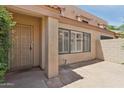 Exterior view of the unit with private patio, security screen door, and window shutters at 4734 W Golden Ln, Glendale, AZ 85302