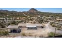 Aerial view of property featuring a car port, desert landscape and mountain views at 48451 N 27Th Ave, New River, AZ 85087