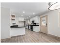 Modern kitchen featuring white cabinets, granite countertops and stainless appliances at 48451 N 27Th Ave, New River, AZ 85087