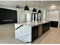 Spacious kitchen with a waterfall island, modern lighting, and stylish finishes at 5088 S Ponderosa Dr, Gilbert, AZ 85298