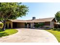 Single-story home with a spacious driveway and mature trees at 518 N Cheri Lynn Dr, Chandler, AZ 85225