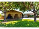 Charming single-story home with mature trees and a well-maintained lawn at 518 N Cheri Lynn Dr, Chandler, AZ 85225