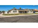 Street view of cozy home with solar panels, clean landscaping, and easy street access at 624 N Ashbrook Cir, Mesa, AZ 85213