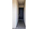 A classic black front door with elegant gold hardware and minimalist trim, set against a neutral exterior wall at 6621 E Villa Rita Dr, Phoenix, AZ 85054