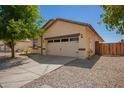 The home has a charming two-car garage and a well maintained low-maintenance desert-style landscape at 7324 S 254Th Dr, Buckeye, AZ 85326