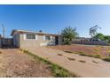 Well-maintained single-story home with a concrete driveway and minimal landscaping at 7619 W Clarendon Ave, Phoenix, AZ 85033