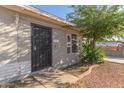 Inviting home entrance with a secure iron gate and well-kept yard at 7619 W Clarendon Ave, Phoenix, AZ 85033