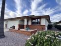 Well-manicured lawn with mature landscaping enhances this inviting home's curb appeal, featuring brick accents at 8161 E Keats Ave # 376, Mesa, AZ 85209