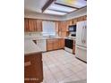 Well-lit kitchen with oak cabinets, white appliances, and tile flooring at 8161 E Keats Ave # 376, Mesa, AZ 85209