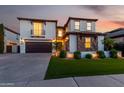 Beautiful two-story home featuring stone accents, a two-car garage, well-manicured lawn, and a balcony over the garage at 861 E Canyon Way, Chandler, AZ 85249