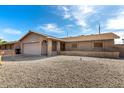 Charming single-story home with a brick facade, desert landscaping, and a two-car garage at 940 S Revere --, Mesa, AZ 85210