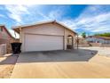 Single-story home with a brick facade, desert landscaping, and a two-car garage at 940 S Revere --, Mesa, AZ 85210