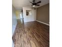 Inviting living room with ceiling fan and light wood-look flooring at 11221 N 91St Dr, Peoria, AZ 85345
