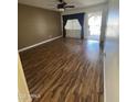 Comfortable living room with a ceiling fan and attractive light wood-look flooring at 11221 N 91St Dr, Peoria, AZ 85345
