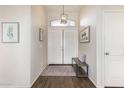 Welcoming foyer featuring a stylish light fixture, decorative wall art, and tile flooring at 1161 N Cole Dr, Gilbert, AZ 85234