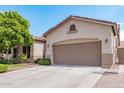 Single-story home showcases a spacious two-car garage, complemented by low-maintenance landscaping at 1161 N Cole Dr, Gilbert, AZ 85234