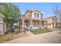 Two-story home with covered porch, stone accents, and a well-maintained front yard at 12022 W Belmont W Dr, Avondale, AZ 85323