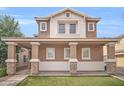 Home with stone column bases on the porch and a manicured front lawn at 12022 W Belmont W Dr, Avondale, AZ 85323