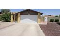 View of the front of the house and the two-car garage with a long, wide driveway at 13012 N 26Th Dr, Phoenix, AZ 85029