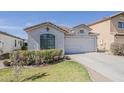 Single-story home features a tiled roof, two-car garage, and a neatly landscaped front yard at 1396 E Leslie Ave, San Tan Valley, AZ 85140