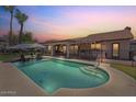 Inviting backyard featuring a refreshing pool, covered patio, and lush landscaping at 1670 E Whitten St, Chandler, AZ 85225